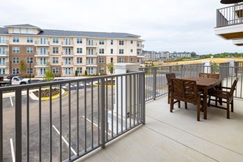 a patio with a table and chairs on a balcony